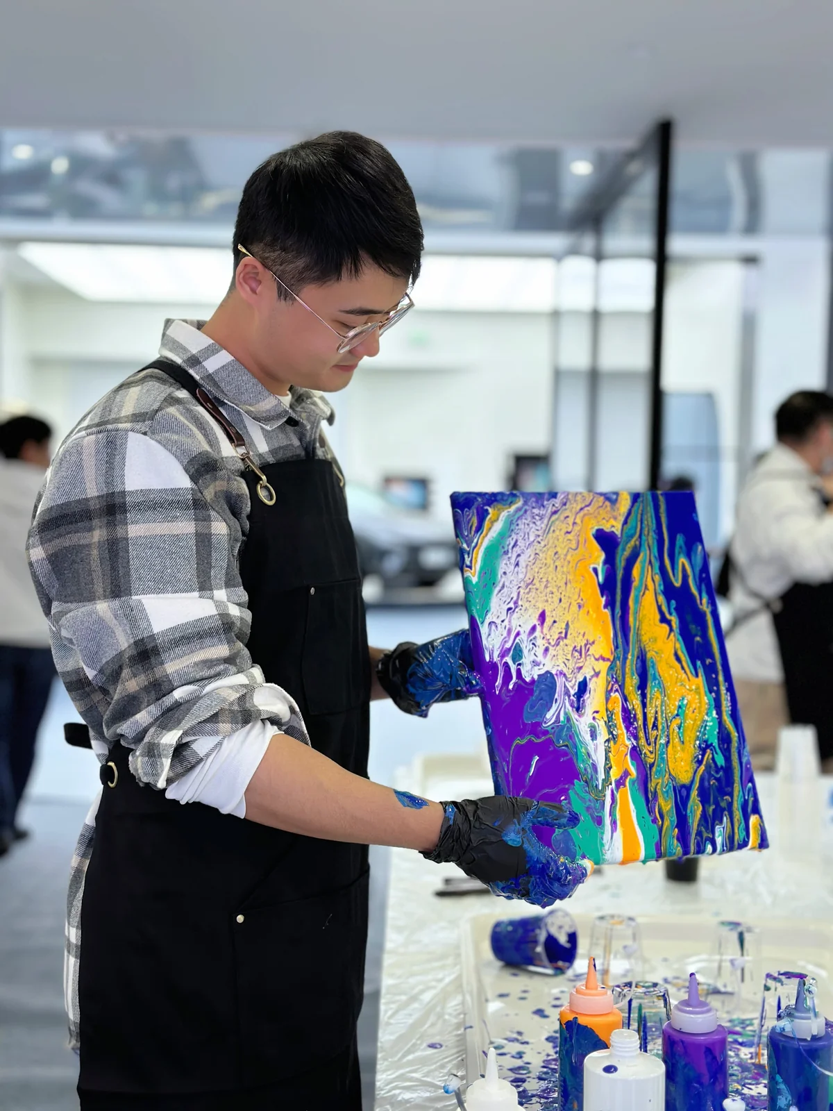 Xingting Wu making a colourful artwork
